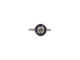 a close up of a diamond and sapphire ring on a white background