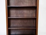 an image of a wooden bookcase with three shelves on top of it