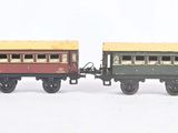 several toy trains are lined up in a row on a white surface
