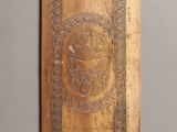 a wooden plaque on the wall that has a picture on it
