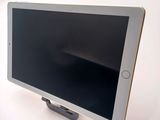 a tablet computer sitting on a stand on a white surface