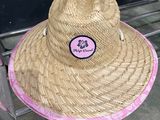 a straw hat sitting on top of a luggage cart