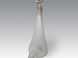 an image of a glass bottle with a handle on a white surface