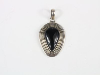 a silver pendant with a black stone in the center