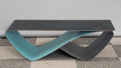 a black and blue bench sitting on a checkered floor
