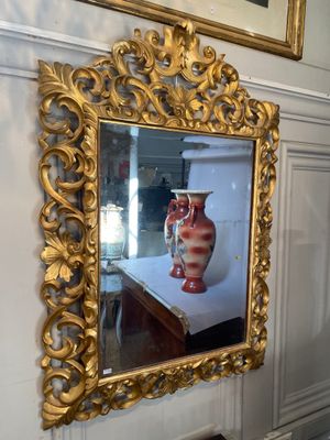 a gold frame with a picture of a vase on it