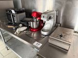 a kitchen counter with a mixer and other appliances on it