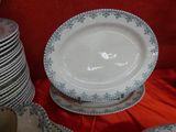 a stack of plates on a red table cloth