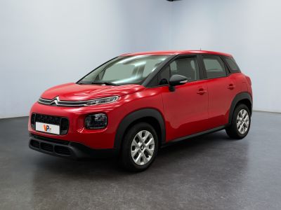 Une Citroën rouge est garée dans une grande pièce