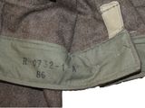 a close up of a military jacket with a tag on it