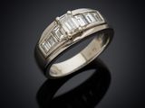 a close up of a diamond ring on a black surface