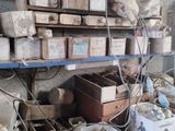 many boxes and boxes on a shelf in a room