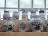 many vases on the window sill in the kitchen