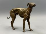 an image of a bronze statue of a dog on a gray background