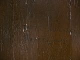 a close up picture of a wooden table with a clock on it