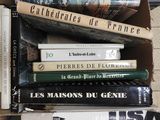 many books stacked on top of each other in a box