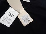 a black t - shirt with a tag on the back of it