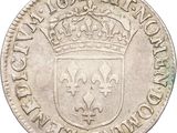 a silver coin with a crown on top of it
