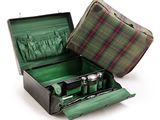 a green suitcase with a checkered cloth inside of it
