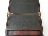 an old wooden box with a black cover and a brown handle