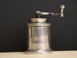 a silver coffee grinder sitting on a table