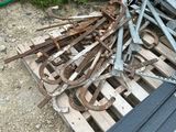 a pile of old tools on a pallet in the dirt