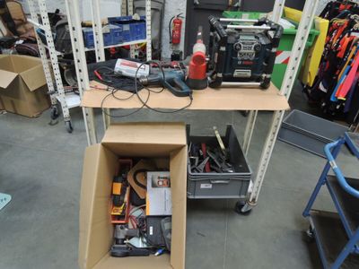 a box of tools sitting on a shelf in a garage