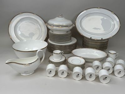 a lot of white and gold dinnerware on the table