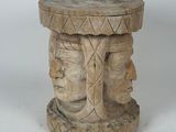 an image of a wooden table with a carved face on it