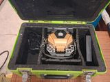 a green case with a yellow and black object inside of it