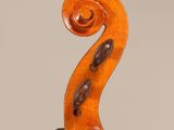 an old violin with a long neck and a long tail