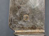 a silver spoon with a handle on a table