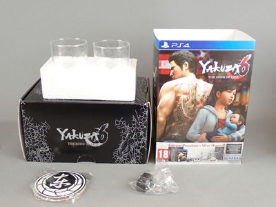 a box with a game and a glass on it