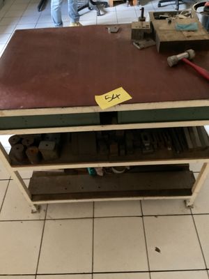 un établi sur lequel sont posés des outils, dans une pièce