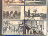 several old black and white photos of people and buildings on a table
