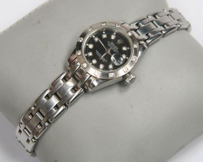 a watch that is sitting on top of a bracelet