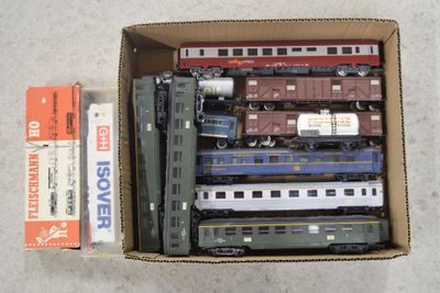 a box full of toy trains sitting on the floor