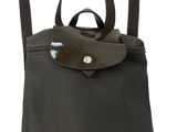 a close up of a black backpack with a brown handle
