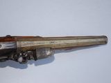 an old gun that is on display on a table