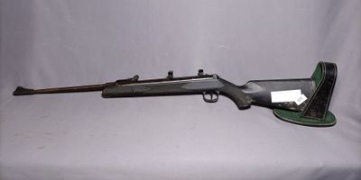 a rifle that is laying on top of a table