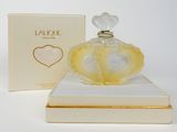 an image of a bottle of perfume sitting on top of a box