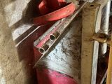 a red fire hydrant and a red shovel in the corner of a room