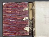 an open book with a red and blue cover sitting on top of a table