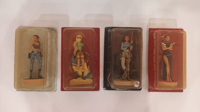 three plastic figurines of a woman and a man on a white surface