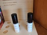three bottles of makeup sitting on a table