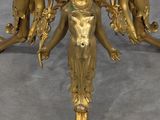 gold plated table with four figurines on top of it