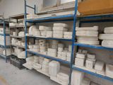 a room with shelves filled with lots of white dishes