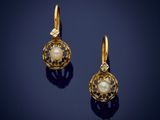 a pair of gold and pearl earrings