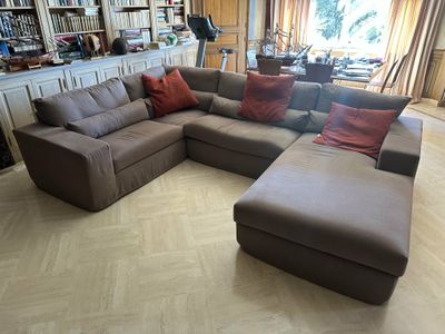 a large sectional couch in the middle of a living room