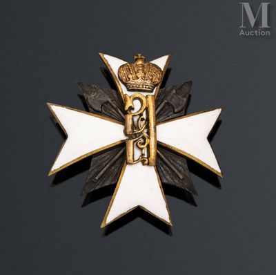 a close up of a white and gold cross with a crown on it